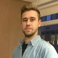 A black and white thumbnail of Andrew Milner, co-founder and executive producer at Alchemy Studio.